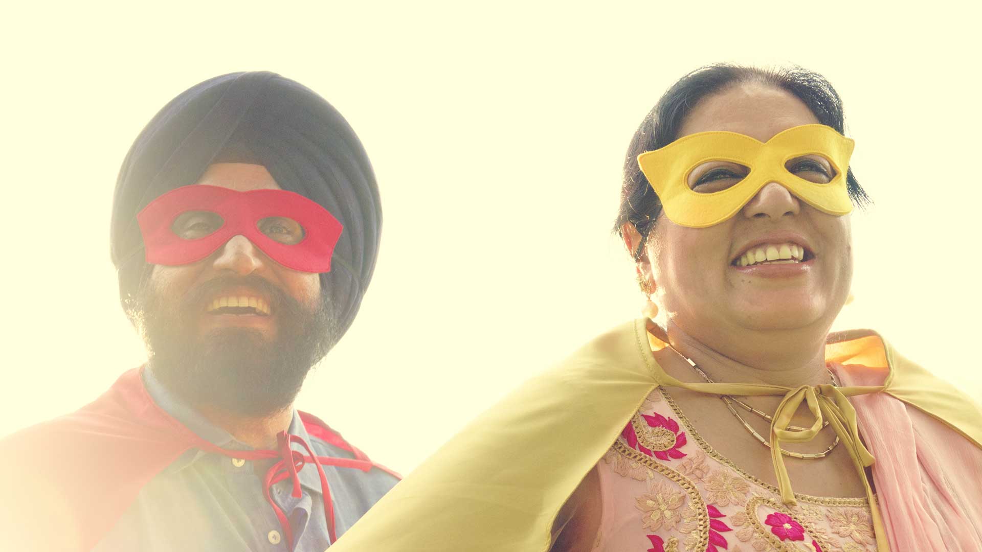 happy and smiling Indian couple wearing superhero masks