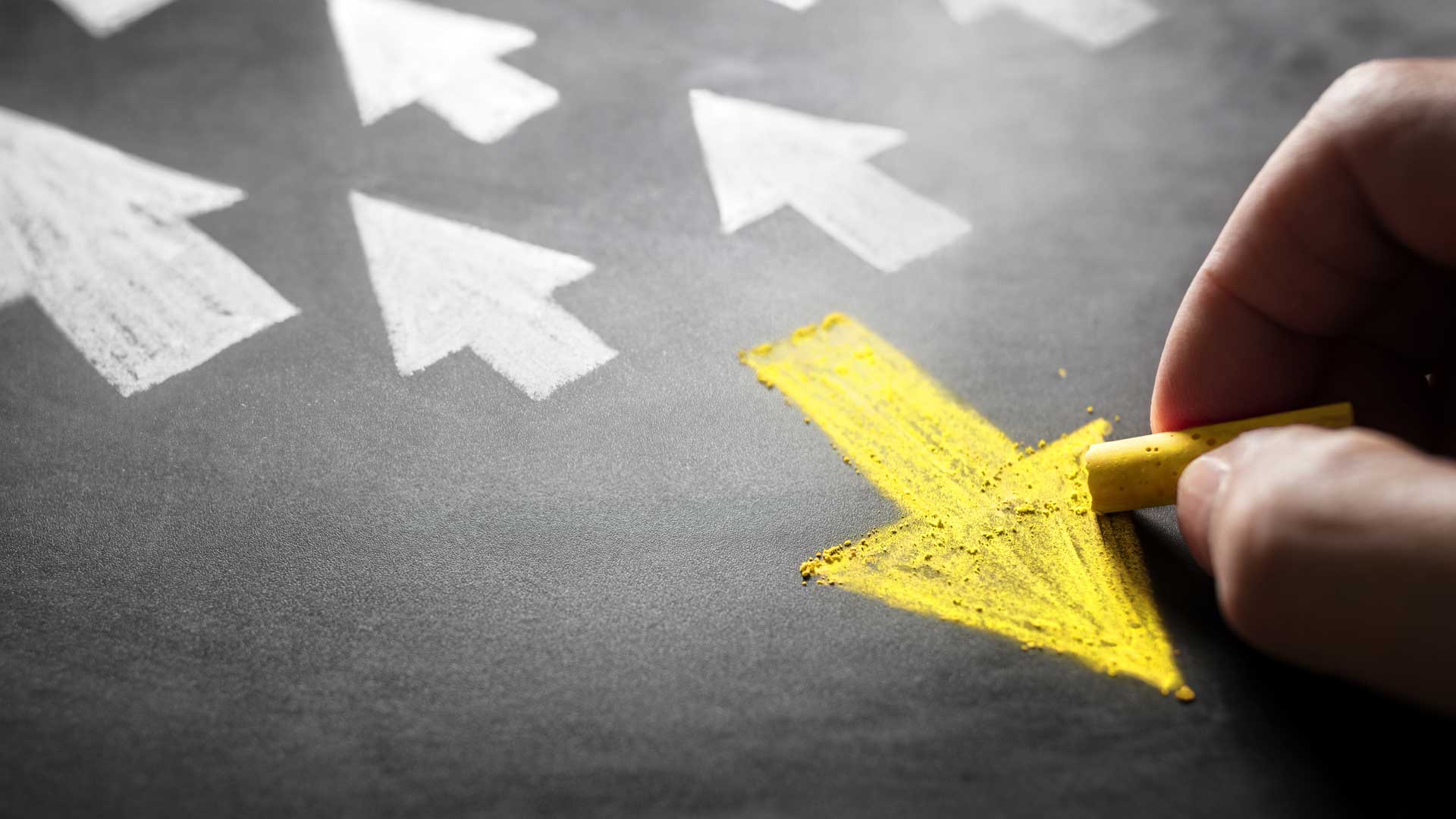 person drawing yellow arrow in the opposite direction of other white arrows